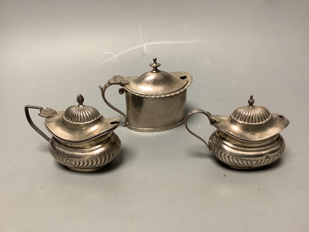 Three assorted silver mustard pots, a silver mounted glass scent bottle and Georgian silver salt.